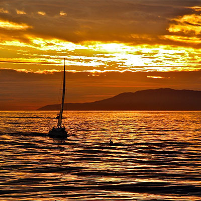photo of a sailboat at sunset