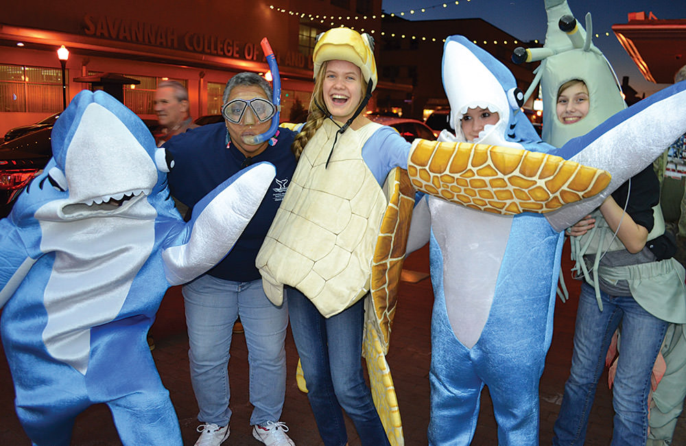 people dressed in ocean themed costumes, a shark, snorkeler, sea turtle, shark and shrimp