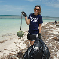 team ocean volunteer removing debris from a beach