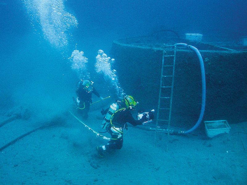 divers removing the monitor turrent