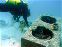 The iron stove in the galley section of the wreck site.  Also located near the galley, electrical components and debris from the water closet or ship s head.