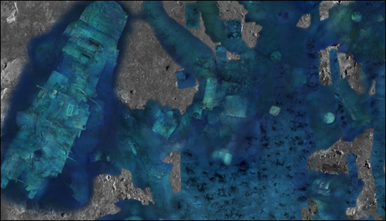 A partially completed mosaic merging sonar and visual imaging data of the area around the stern.