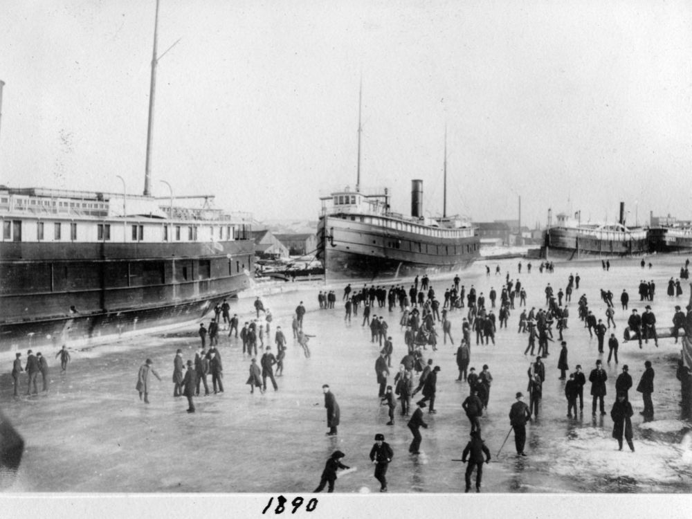 Historic image of steamers in the Manitowoc River in winter.