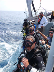 Divers prepare to dive over the side of the R-8501 (NOAA)