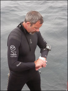 Russ Green checks out his gear before diving (NOAA)
