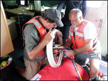 Doug Kessling and Greg McFall set up the recompression chamber onboard the R-8501 (NOAA)