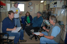 Science team discussion in the dry lab of the NOAA Ship McArthur II with (left to right) Peter Etnoyer, Sean Rooney, Jennifer Bright, Colby Brady, and Ed Bowlby.