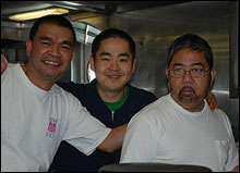 Galley crew Orcy Tan, Luke Staiger, and Chief Steward Art Mercado take a break from making lunch.