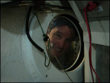 Aquanaut Scott Donahue looks through a portal between the wet porch and the entry lock.
