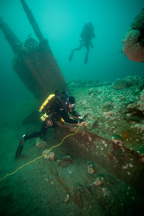 divers examining a wreck
