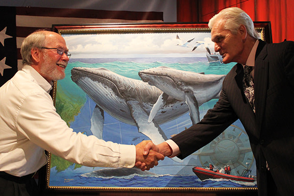 Craig MacDonald, superintendent of Stellwagen Bank National Marine Sanctuary, thanks artist Tom Freeman for his sanctuary commemorative painting