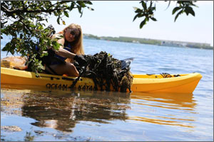 A University of Florida student on an alternative spring break in the Florida Keys National Marine Sanctuary pulls marine debris out of the water.