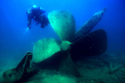 Diver exploring underwater shipwreck