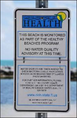 Figure 12. The Florida Department of Health posts swimming advisories at beaches throughout the Florida Keys. This sign indicates if it is advisable or not to swim due to water quality issues such as fecal coliform levels. (Photo: NOAA/FKNMS)