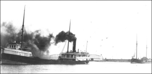 Figure 11. The steam barge Oscar T. Flint with a schooner barge in tow. Carrying bulk cargo in its own hold, while towing additional barges known as consorts, allowed the steam barge to maximize the amount of cargo conveyed in a single trip. Barges were often aging schooners, as seen here. In 1909, the Flint caught fire and sank in 30 feet of water in Thunder Bay (Historical Collections of the Great Lakes, Bowling Green State University).