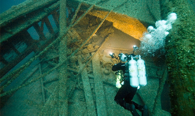 Photo of diver and shipwreck