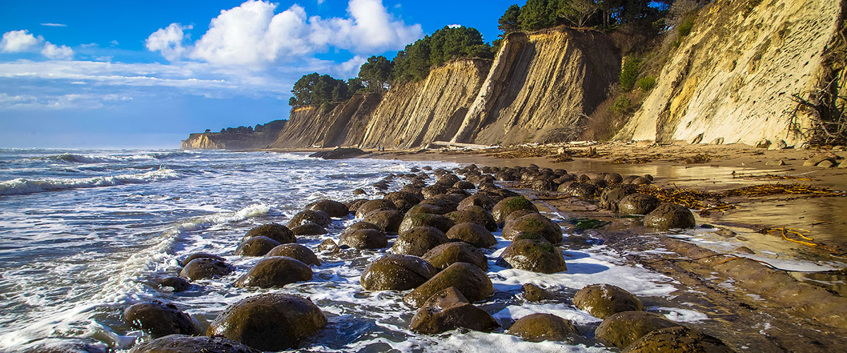 photo of rocks, cliffs and a beach in greater farallones