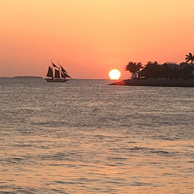 photo of a sunset and a boat in key west florida