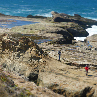 photo of people exploring on cliffs