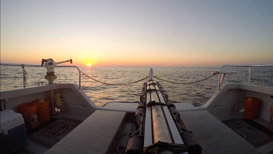 pview of a sunset from the stern of a boat