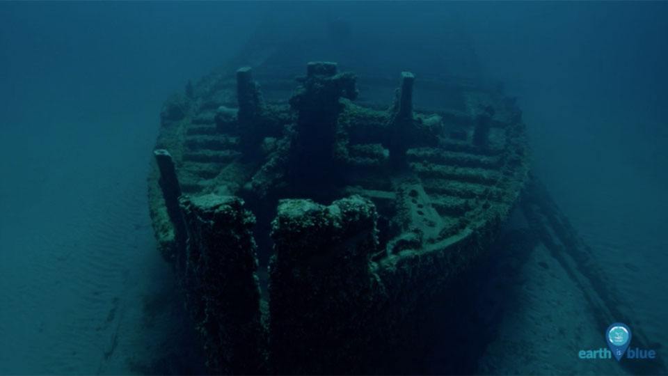 a shipwreck rests on the seafloor