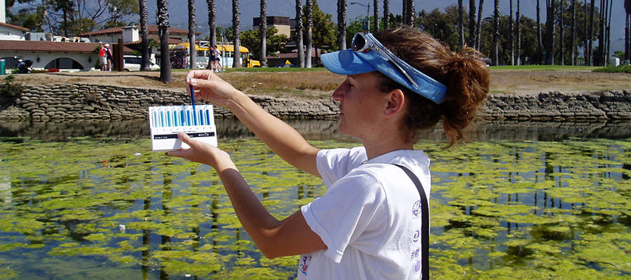 photo of student doing water quality monitoring