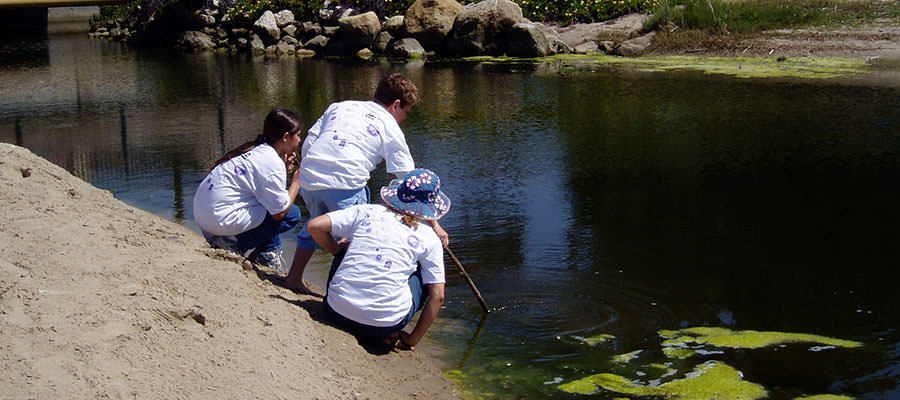 photo of students monitoring a lake