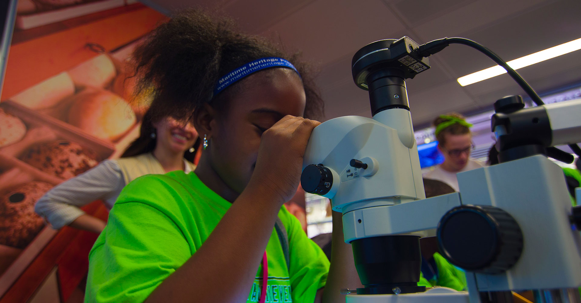 students looking through a microscope