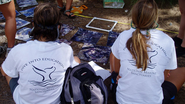 photo of two girls wearing dive into education tshirts