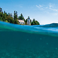 view of presque isle lighthouse from the water in thunder bay national marine sanctuary