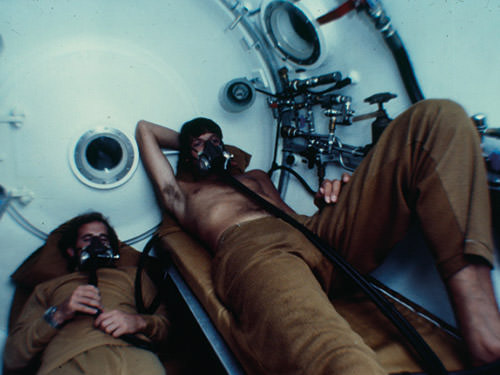 two people in a decompression chamber