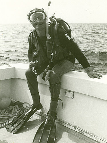diver sitting on the side of a boat