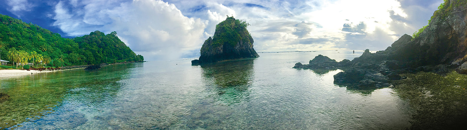 panoramic view from the shore of Ofu, the reef and cove are visible