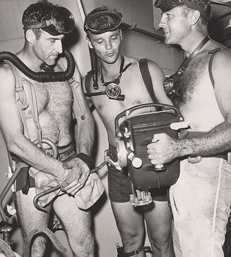 volunteer divers examine their gear