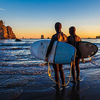 two surfer ready to enter the water at olympic coast national marine sanctuary