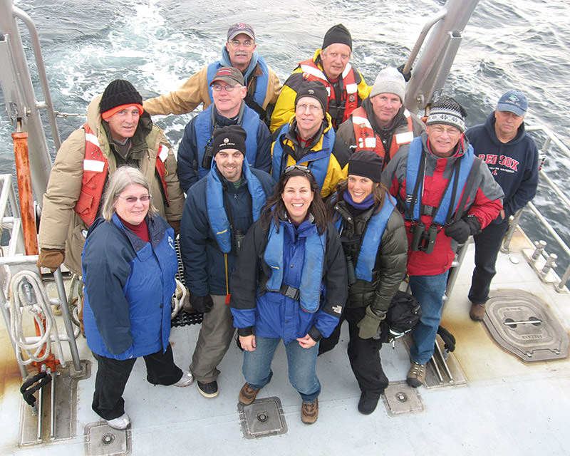 Volunteers and staff on deck posing for a photo
