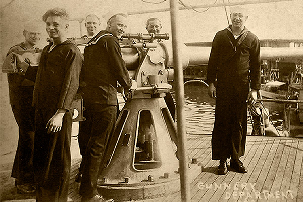 members of the gunnery deptartment standing next to the conestoga's gun