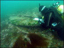 NOAA archaeologist Hans Van Tilburg documents the Hassler's rudder
