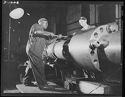 two men working on an engine