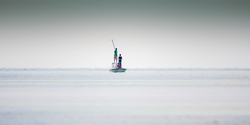 pole fisherman on a boat fishing