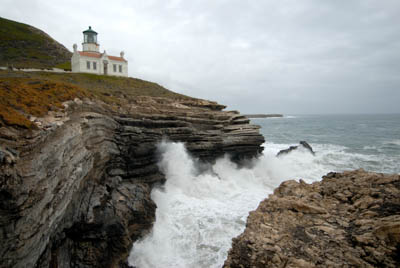 waves crashing on the rocks below point conception lighthouse