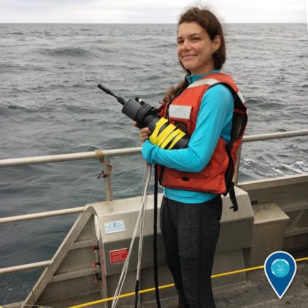 Michelle Modest holds an underwater hydrophone ready for deployment
