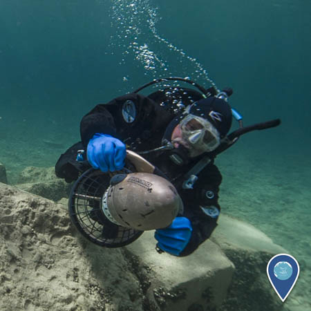 a noaa diver using a diver diver propulsion vehicle, or scooter