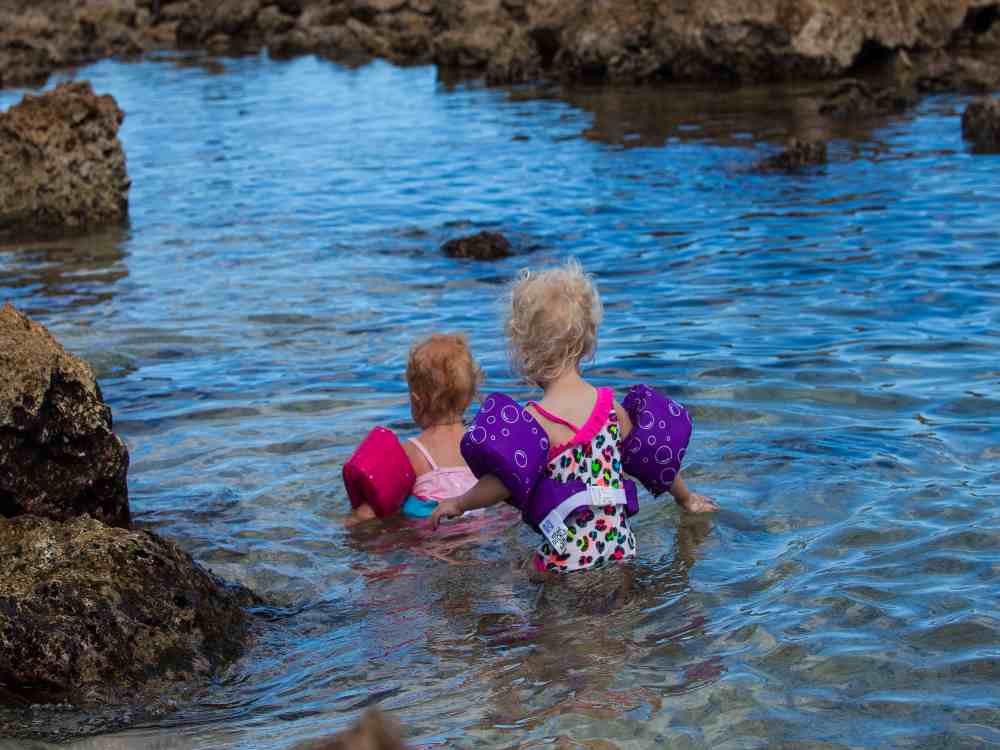 children in the water at pupukea beach