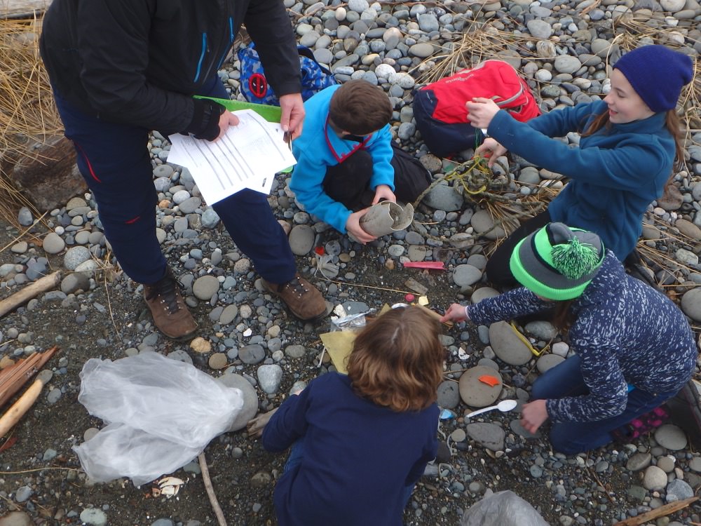 Students conduct marine debris monitoring on the beach