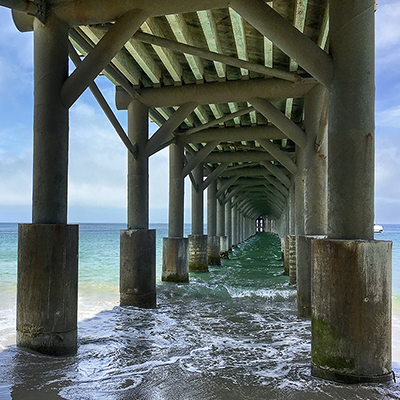view of the ocean underneath a pier