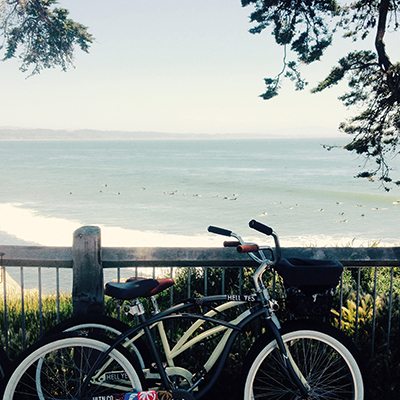 bikes on a sidewalk above the beach