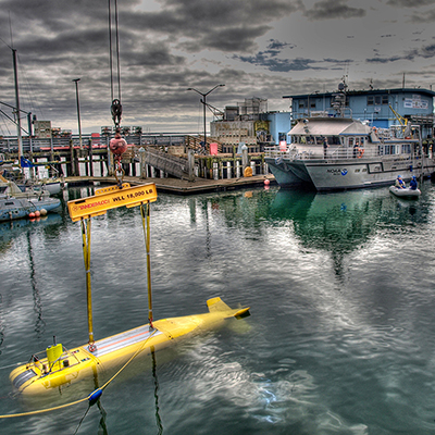 harbor with yellow autonomous underwater vehicle in lower left