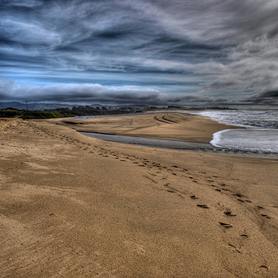 footsteps on a beach on a cloudy day