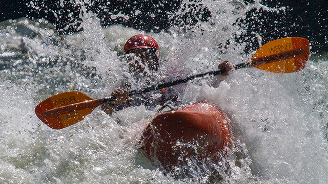 white-water kayaker in rapids